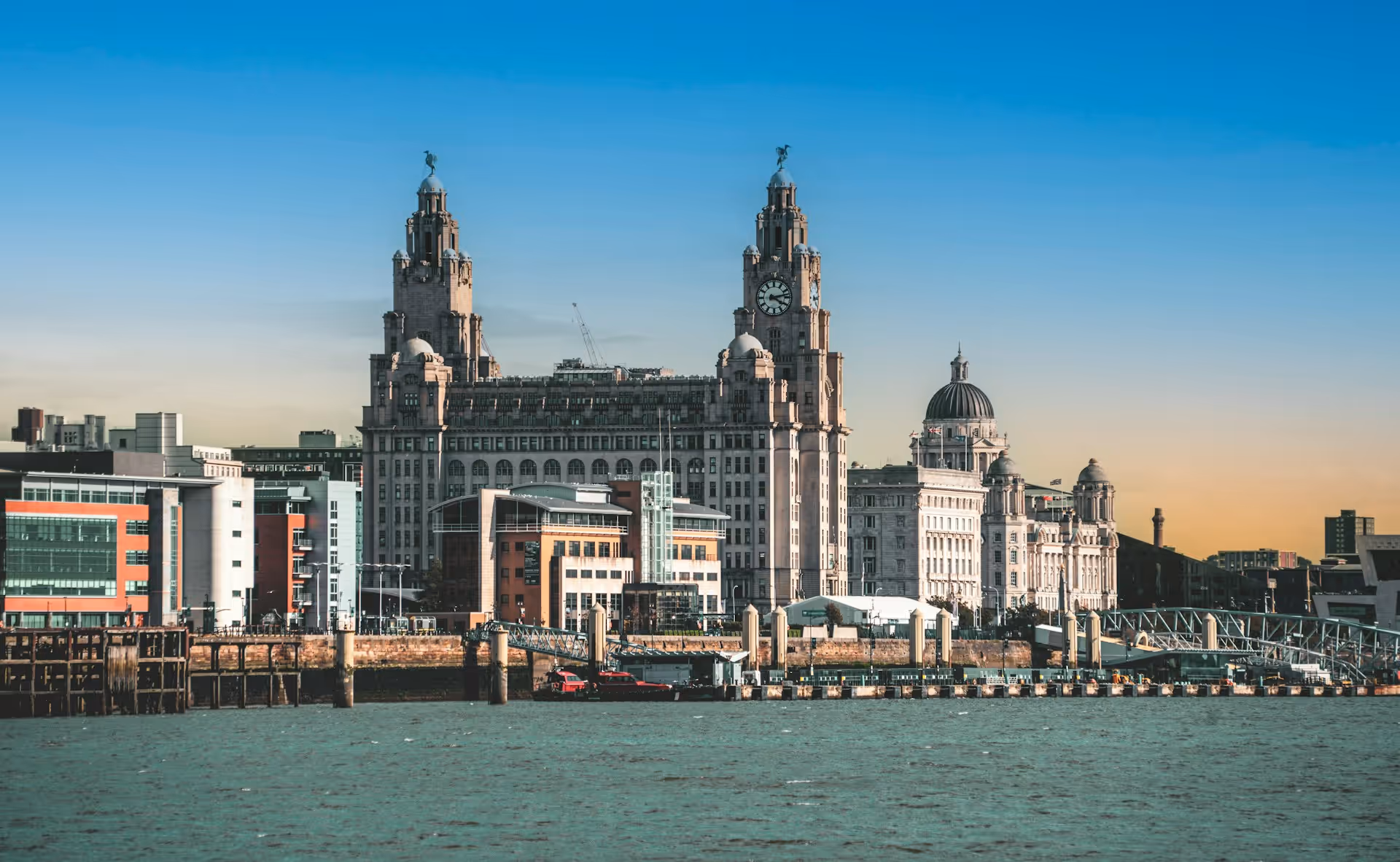 Liverpool's waterfront at Pier Head, with the Royal Liver Building and the Port of Liverpool Building seen from across the Mersey